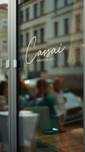 a window of a restaurant with people in the background at CASA CASSAI - Casa Milo in Meiningen