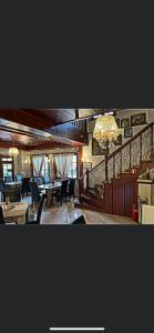 a restaurant with tables and chairs and a chandelier at Hotel Ostrova in Plovdiv