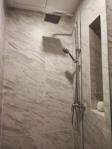 a shower with a glass door in a bathroom at Trevor bathtub Imperio residence seaview jonker5min in Melaka +20 photos
