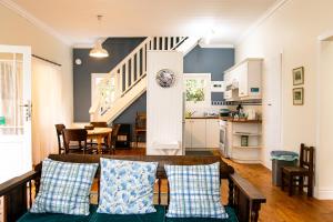 a living room with a table and a kitchen at Beside Still Waters in Wilderness