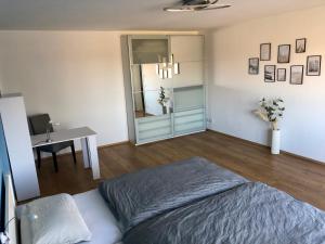 a bedroom with a bed and a table and a desk at Ferienwohnung am Teutoburger Wald in Berghagen