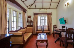 a living room with a couch and a table at MAI HOUSE HERITAGE HOTEL in Fort Kochi