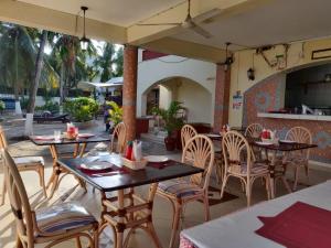a restaurant with tables and chairs on a patio at Glory Holiday Resort in Mombasa