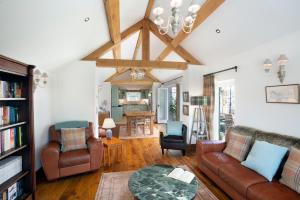 a living room with a couch and a table at Long Roods cottage in Bakewell