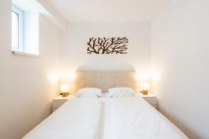 A bed or beds in a room at Apartmány Oravskie