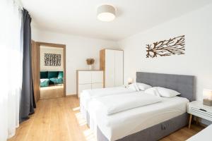 A bed or beds in a room at Apartmány Oravskie