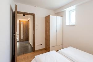 A bed or beds in a room at Apartmány Oravskie