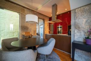 a kitchen and dining room with a table and chairs at Near Boavista - Free Parking in Porto
