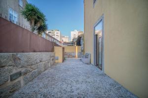 an empty alleyway between two buildings in a city at Near Boavista - Free Parking in Porto