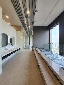 a large bathroom with a large bed and mirrors at Maxhome at Lucentia Bukit Bintang City centre KL in Kuala Lumpur