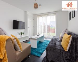 Newbuild 4bed - City Centre - Free secure parking! By Hinkley Homes Short Lets & Serviced Accommodation في ليفربول: غرفة معيشة مع أريكة وتلفزيون