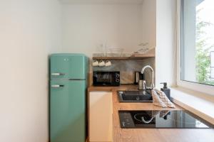 A kitchen or kitchenette at Apartmány Oravskie