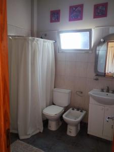 a bathroom with a toilet and a sink at Unelem Tupungato in Tupungato