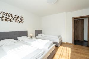 A bed or beds in a room at Apartmány Oravskie