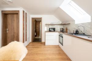 A kitchen or kitchenette at Apartmány Oravskie
