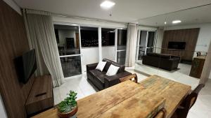 a living room with a couch and a table at Flat Brookfield Towers 2309 in Goiânia