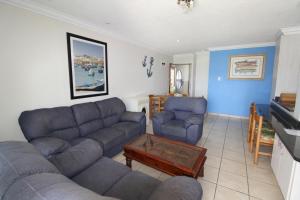 a living room with a couch and two chairs and a table at Boulevard 8 in Margate