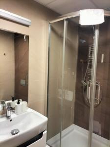 a bathroom with a shower and a sink at Hotel ŚWIT in Krakow