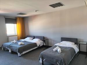 2 posti letto in camera con asciugamani di Hotel ŚWIT a Cracovia