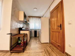 una pequeña cocina con nevera y puerta en Kuća za odmor ,,Valvero’’, en Vrbanja