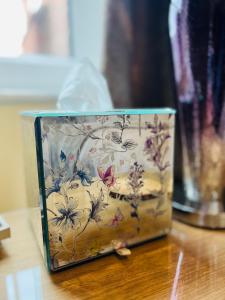 a box with a floral pattern on it sitting on a table at Ashleigh House in Carlisle