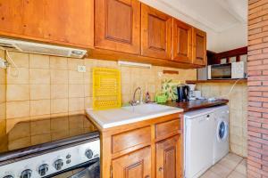 a kitchen with a sink and a washing machine at Maison de 3 chambres avec piscine partagee et wifi a Lagrasse in Lagrasse