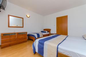 Postel nebo postele na pokoji v ubytování Apartments Milivoj