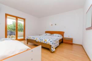 Postel nebo postele na pokoji v ubytování Apartments Milivoj