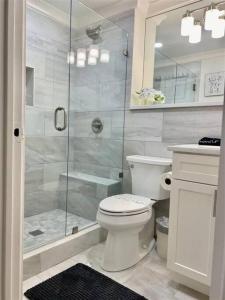 a bathroom with a toilet and a glass shower at Downtown! 24h Concierge! Private Balcony! Highrise Views in Atlanta