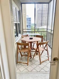 a patio with a table and chairs on a balcony at Downtown! 24h Concierge! Private Balcony! Highrise Views in Atlanta