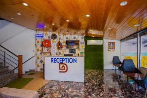 a reception booth with a sign in a room at HOTEL DOON in Dehradun