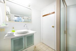 a bathroom with a sink and a shower at Golden Age Motor Inn in Queanbeyan