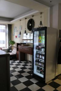 a refrigerator filled with lots of drinks on a checkered floor at Hotel Berliner Hof in Düsseldorf