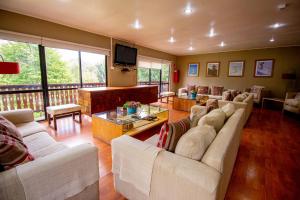 a large living room with couches and a television at Hotel Nevados de Chillan in Nevados de Chillan