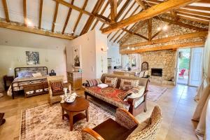 a large living room with a bed and a couch at Beautiful guest house for two people on the bank of the Dordogne river in Siorac-en-Périgord