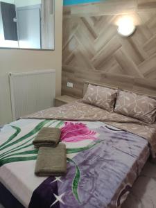 a bedroom with a bed with two towels on it at GCM 2 ROOMS kentro in Katerini