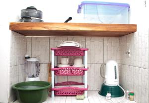a pink shelf in a kitchen with a sink at GP HOUSES in Cotonou