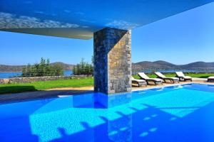 a swimming pool in a house with a view at Villa Marina by PosarelliVillas in Elounda