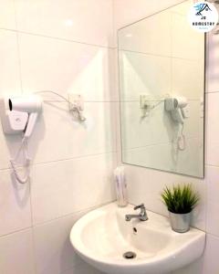 a white bathroom with a sink and a mirror at THE WAVE 3 ROOMS & 2 BATH CONDO - Near JONKER in Melaka