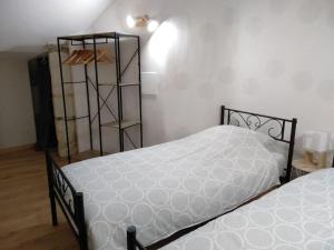a bedroom with two beds and a book shelf at La tour du logis, gîte 4 * à 15 min du Futuroscope 