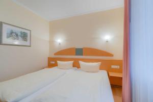 Ein Bett oder Betten in einem Zimmer der Unterkunft Villa Elfeld 2 Whg. 717