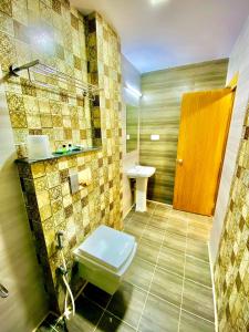 a bathroom with a toilet and a sink at Sheraton Grande Hotel - Business Class Hotel - Near Central Railway Station in Chennai