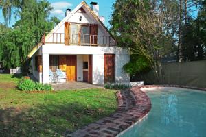 a house with a swimming pool in front of it at El Remanso in Villa General Belgrano