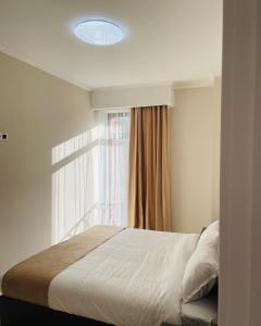 a bedroom with a large bed with a window at Tsaghkadzor Alvina complex in Tsaghkadzor