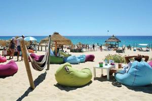 a group of people sitting in hammocks on a beach at Apartamento T2 - Grândola Vila Morena in Grândola