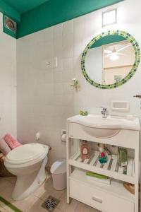 a bathroom with a toilet and a sink and a mirror at Habitación Casa de Familia in Buenos Aires +26 photos