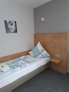 Schlafzimmer mit einem Bett mit einem Kopfteil aus Holz in der Unterkunft Desperados Hotel in Bergen