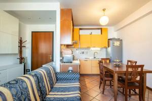 a living room with a couch and a table in a kitchen at SUITE con 2 Balconi - 6 Guest in Prato