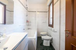 a white bathroom with a toilet and a sink at SUITE con 2 Balconi - 6 Guest in Prato