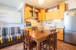 a kitchen with a wooden table and a refrigerator at SUITE con 2 Balconi - 6 Guest in Prato +4 photos